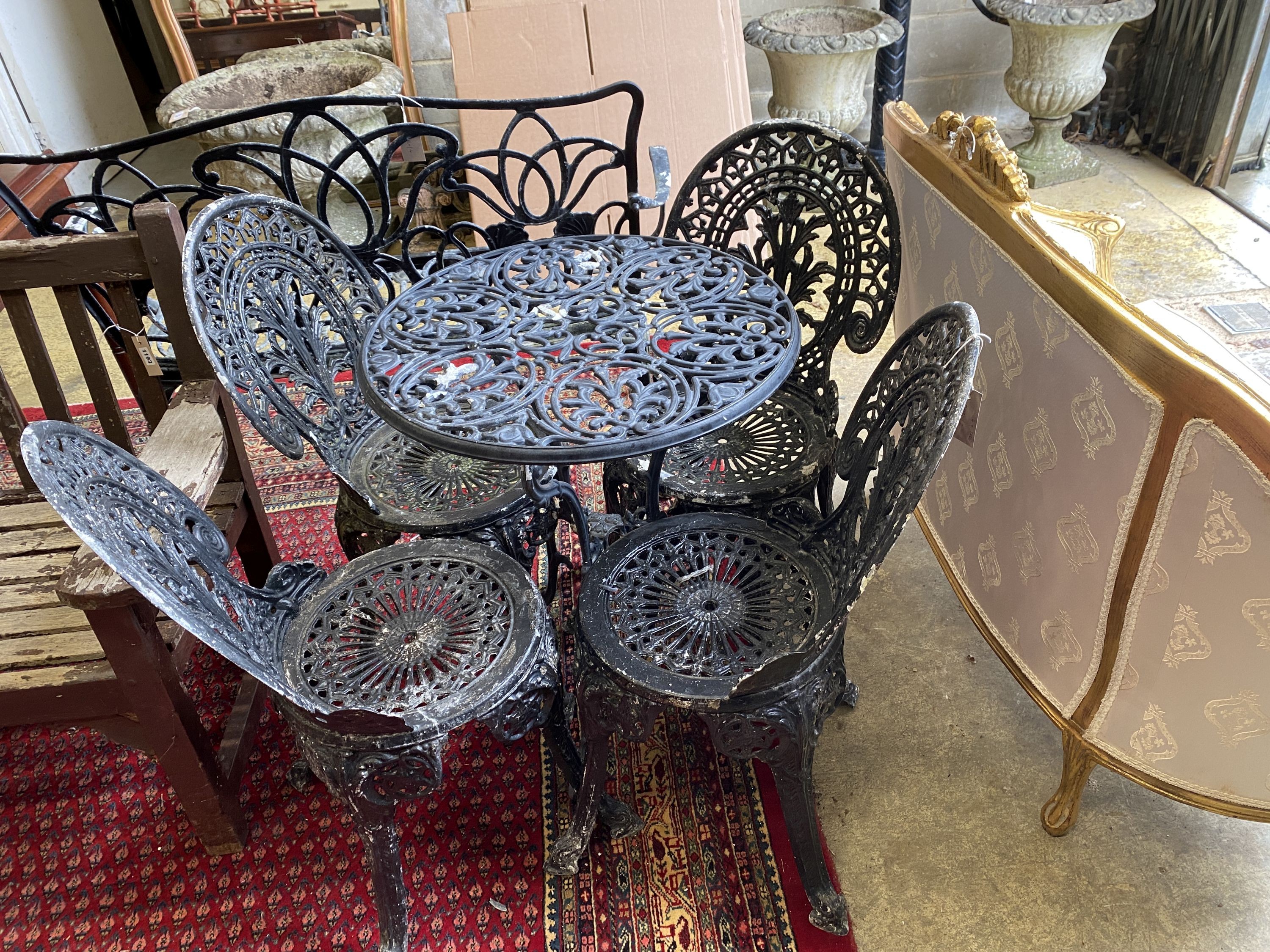 A painted aluminium circular garden table, diameter 60cm together with four aluminium garden chairs